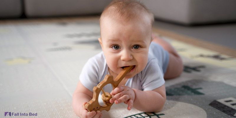 teething baby with a teether