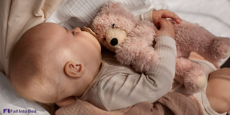 baby with stuffed animal in sleep