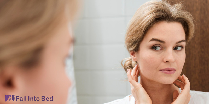 woman checking face after waking up from sleeping with hands above head