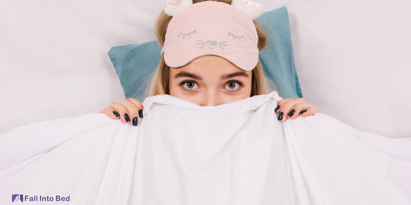 woman under blanket pretending to be asleep