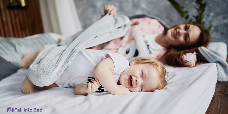 mother waking up baby from heavy sleep