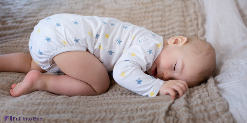 baby with butt in the air sleeping in froggy position