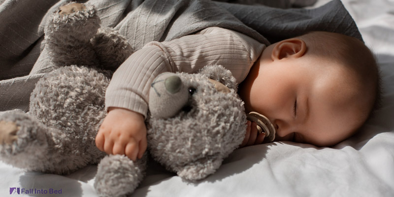 baby sleeping with stuffed animal